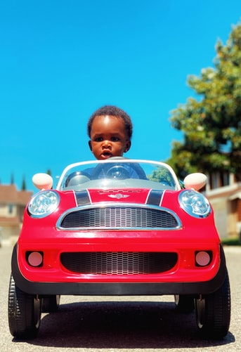 Kiddie luxury cars - Boy with red car