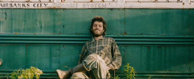 Chris McCandless in from of the Into the Wild bus