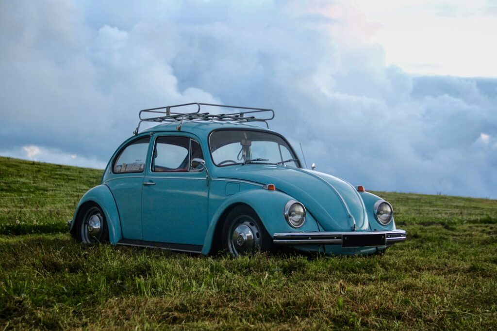 retro powder blue volkswagen beetle in field
