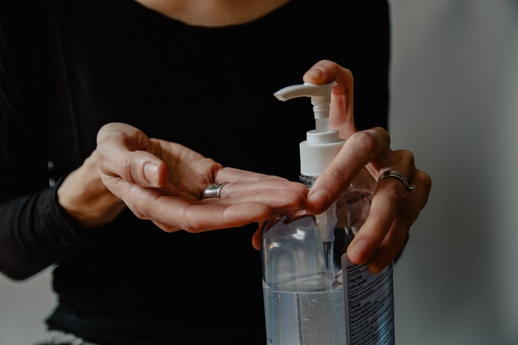 person using hand sanitizer